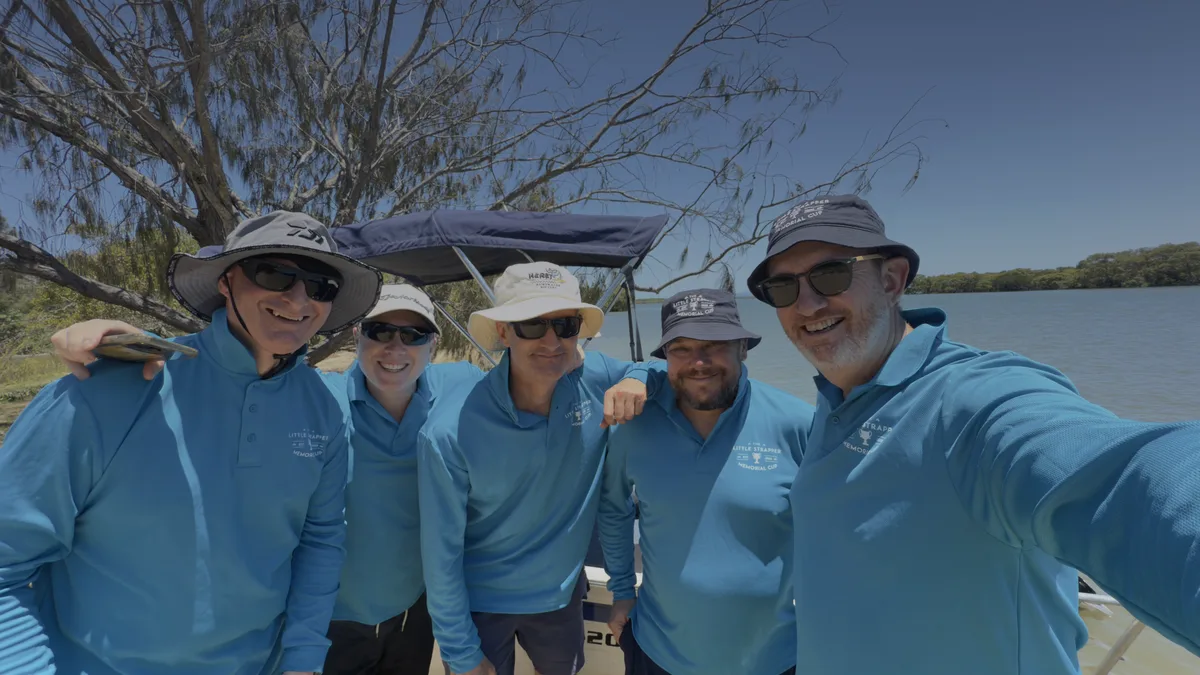 A tour crew in matching shirts on a riverboat.